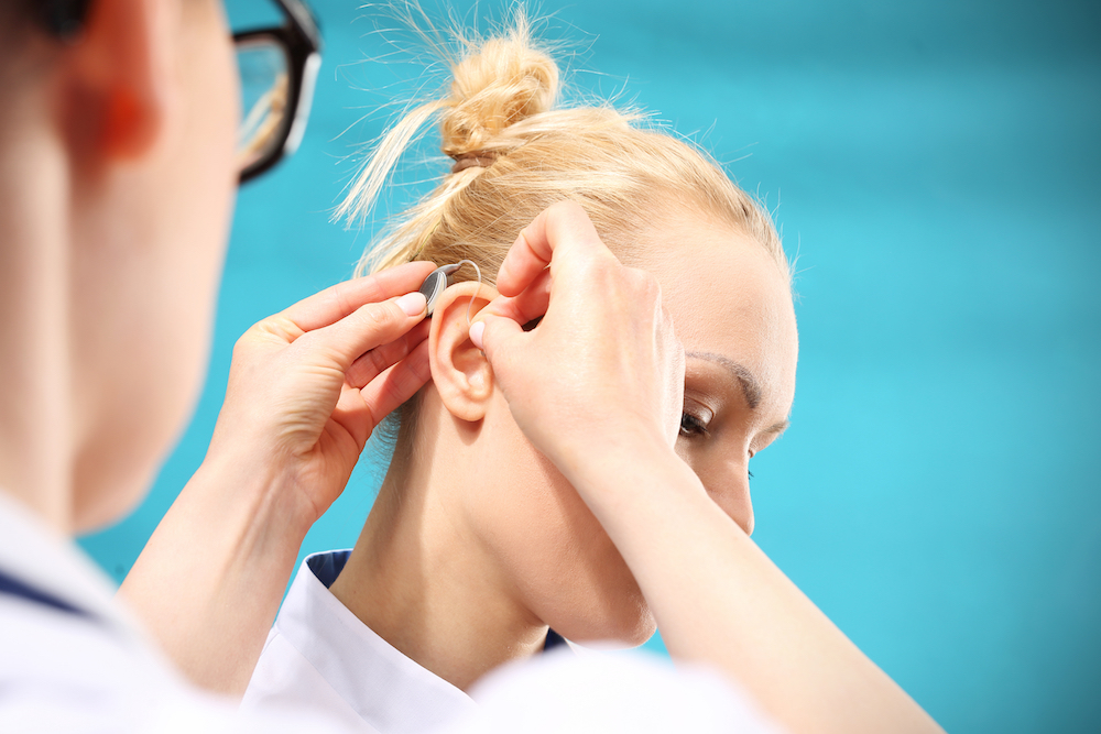 a professional hearing aid fitting in progress