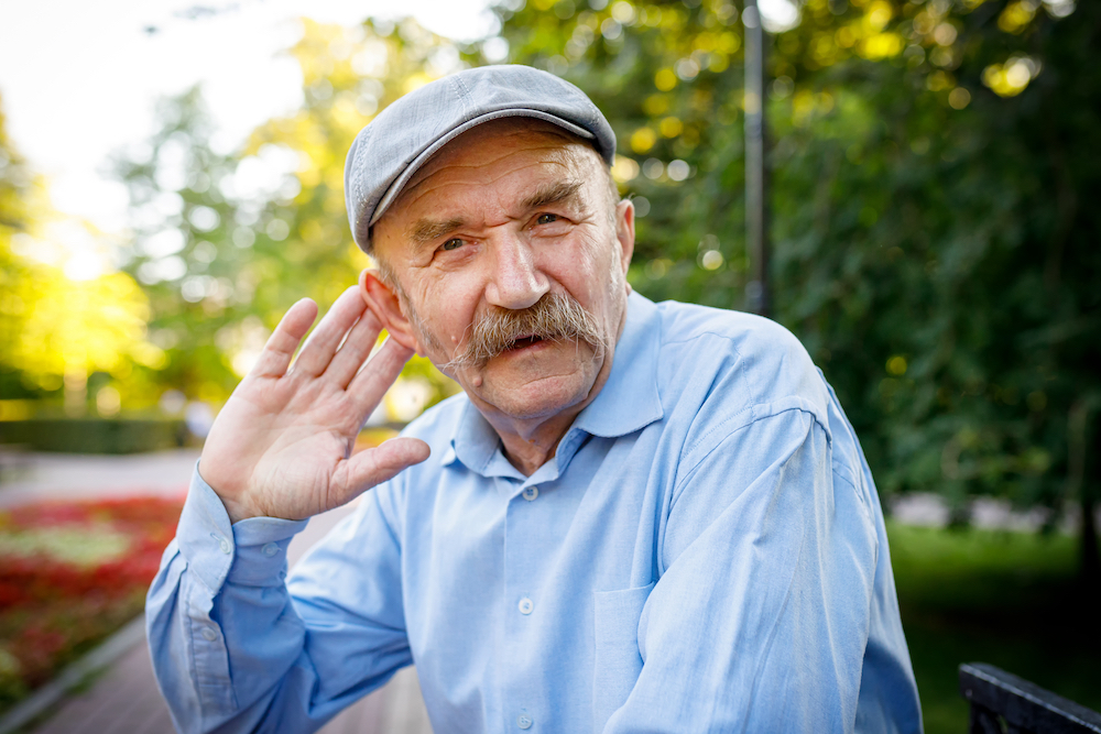 older gentleman cupping hand to ear