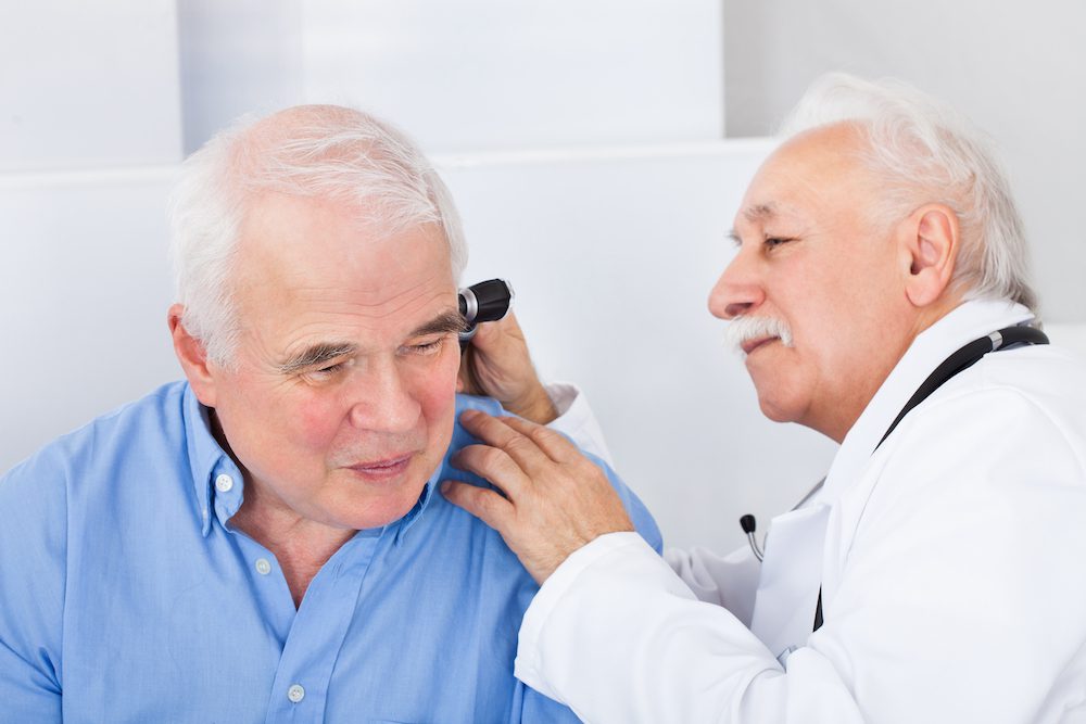 older gentleman in hearing clinic for diagnostic audiologic evaluation