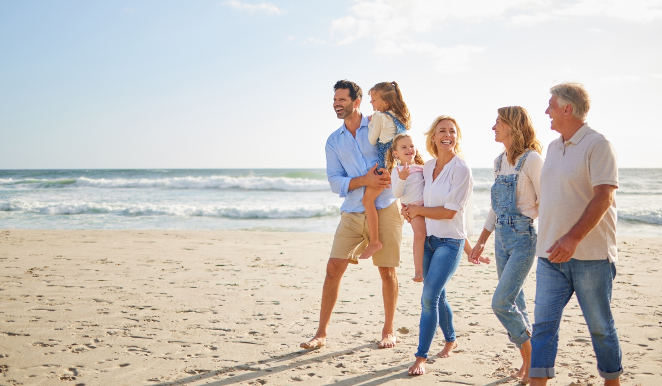 Grandparents parents and children by ocean water