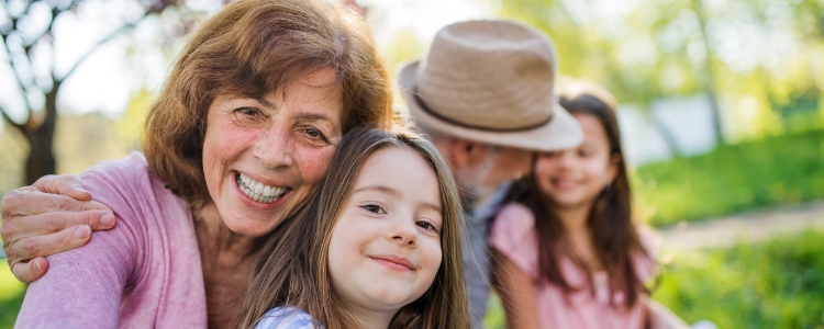 spring grandparents sitting outside with grandchildren spring grandparents sitting outside with grandchildren