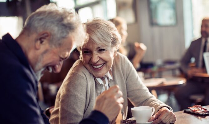 cta stacked senior couple enjoying coffee in modern cafe