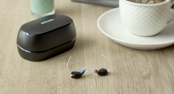 cta stacked oticon zeal hearing aids charging case by coffee cup