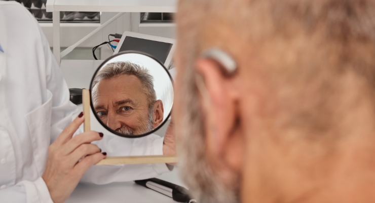 cta stacked middle aged man trying on hearing aids
