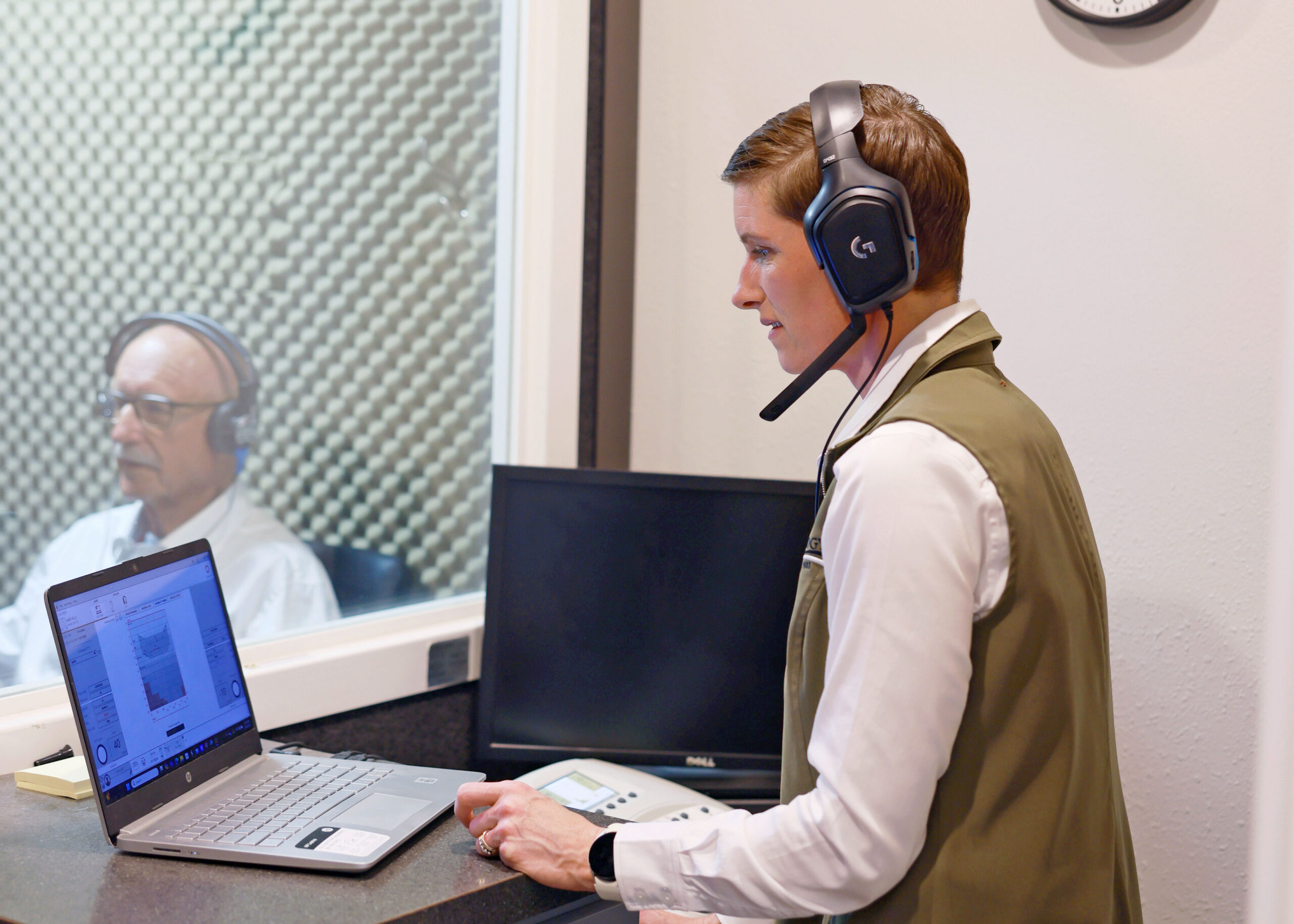 audiologist performing hearing test in soundbooth
