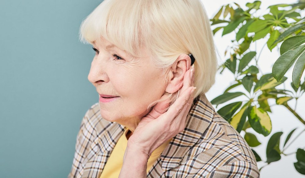 hearing aid on ear mature woman