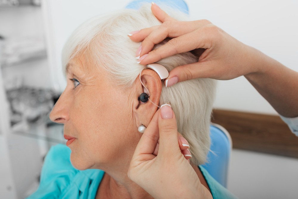 side angle of hearing loss patient during a hearing aid fitting appointment