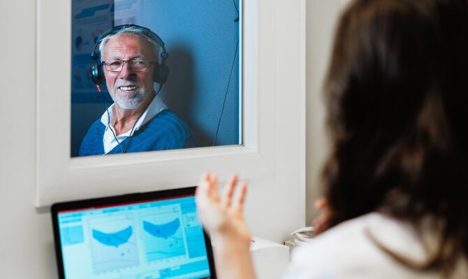 cta stacked senior man hearing test in sound booth