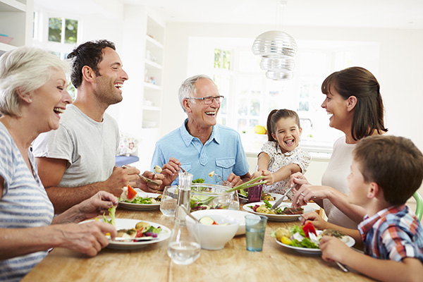 a family gathered at the dinner table eating a feast