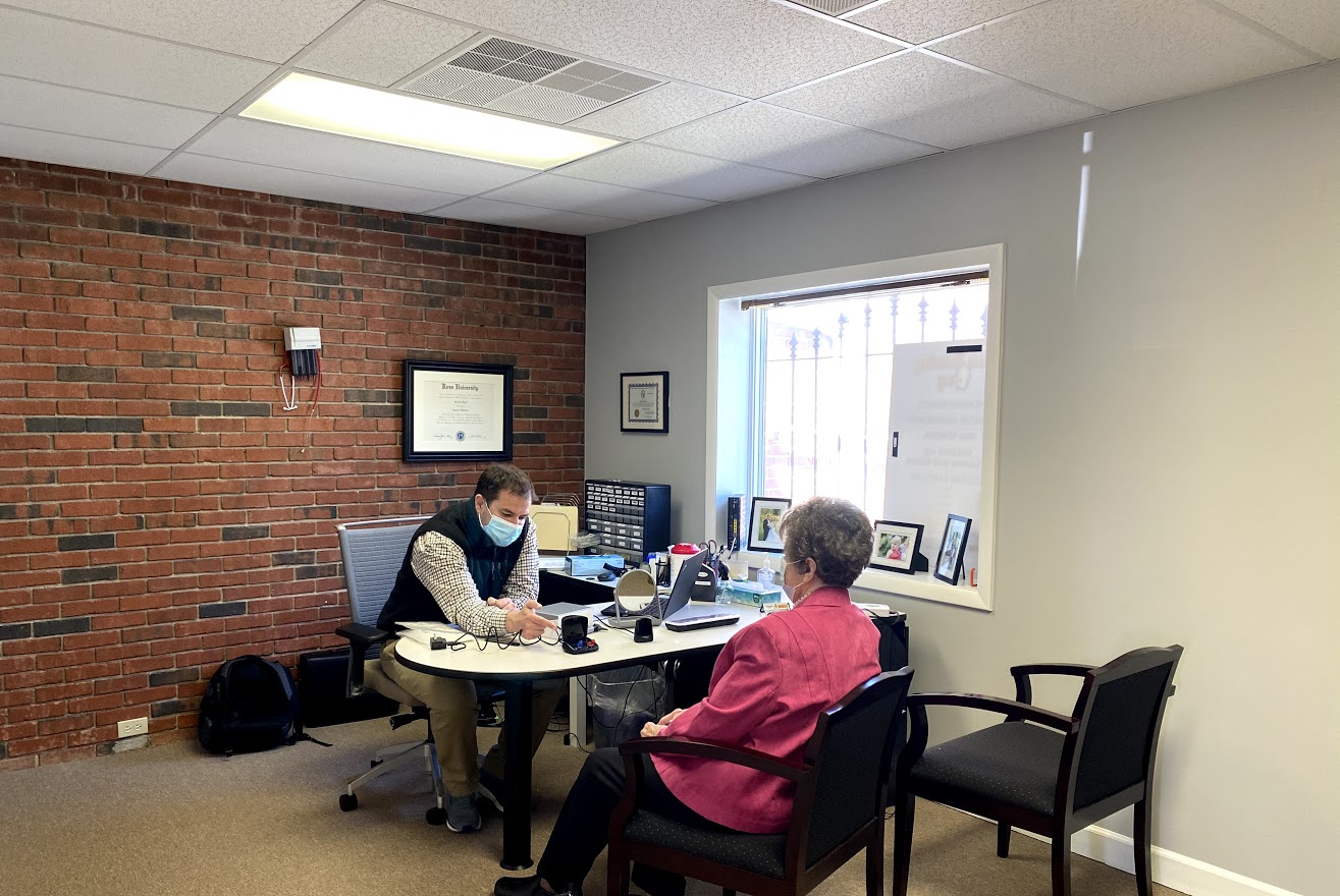 middle aged man receiving hearing test from professional ear doctor