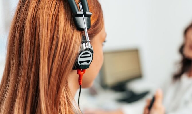 cta stacked middle aged woman putting on earphones for hearing exam