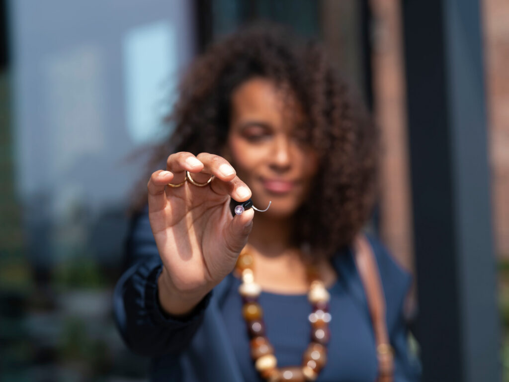 oticon zeal woman with product in hand