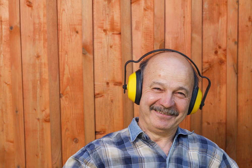 smiling gentleman wearing professional hearing protection