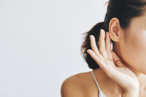 Crop woman touching face