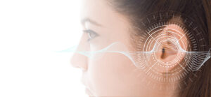 Hearing test showing ear of young woman with sound waves simulation technology