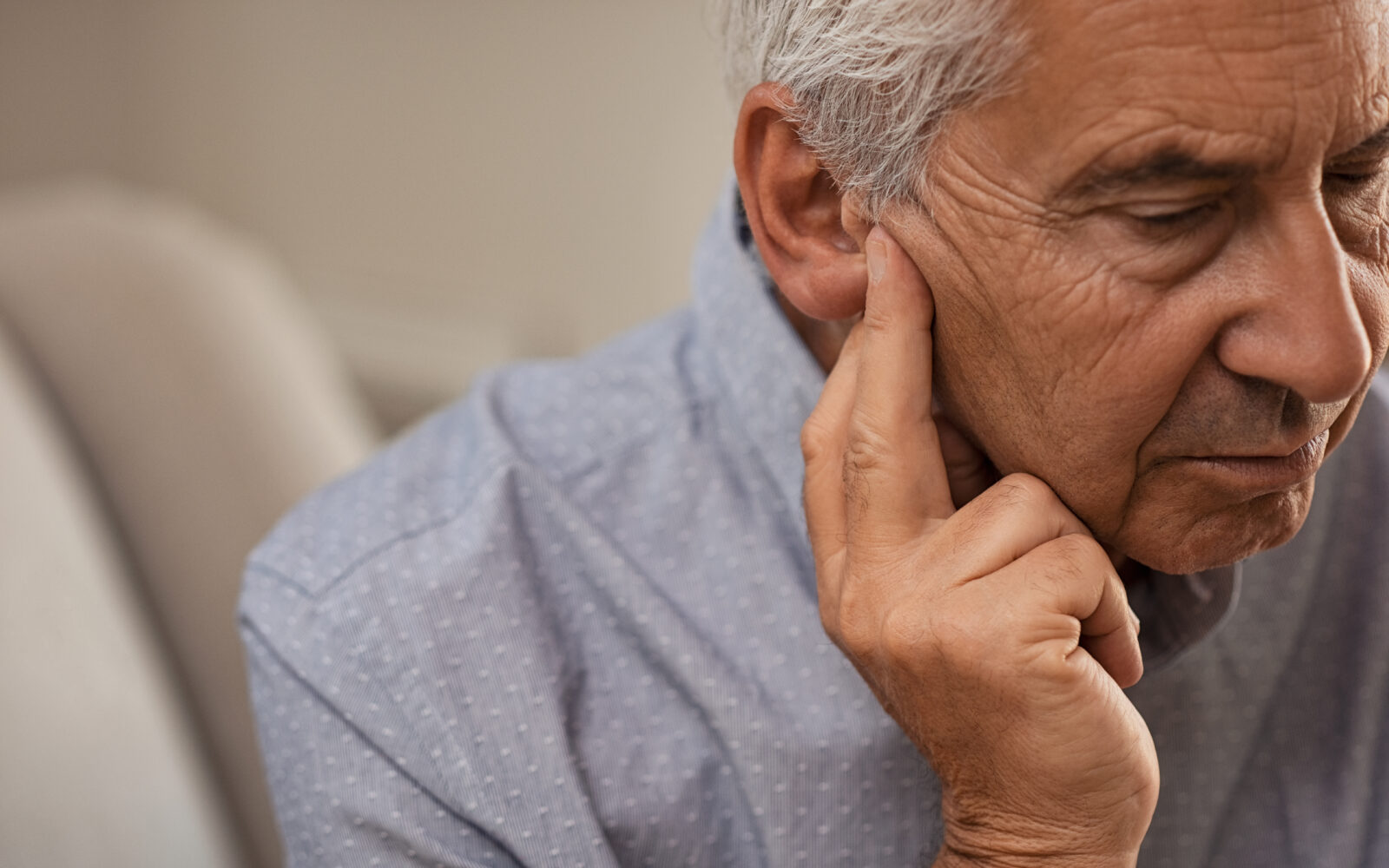Senior man with hearing problems