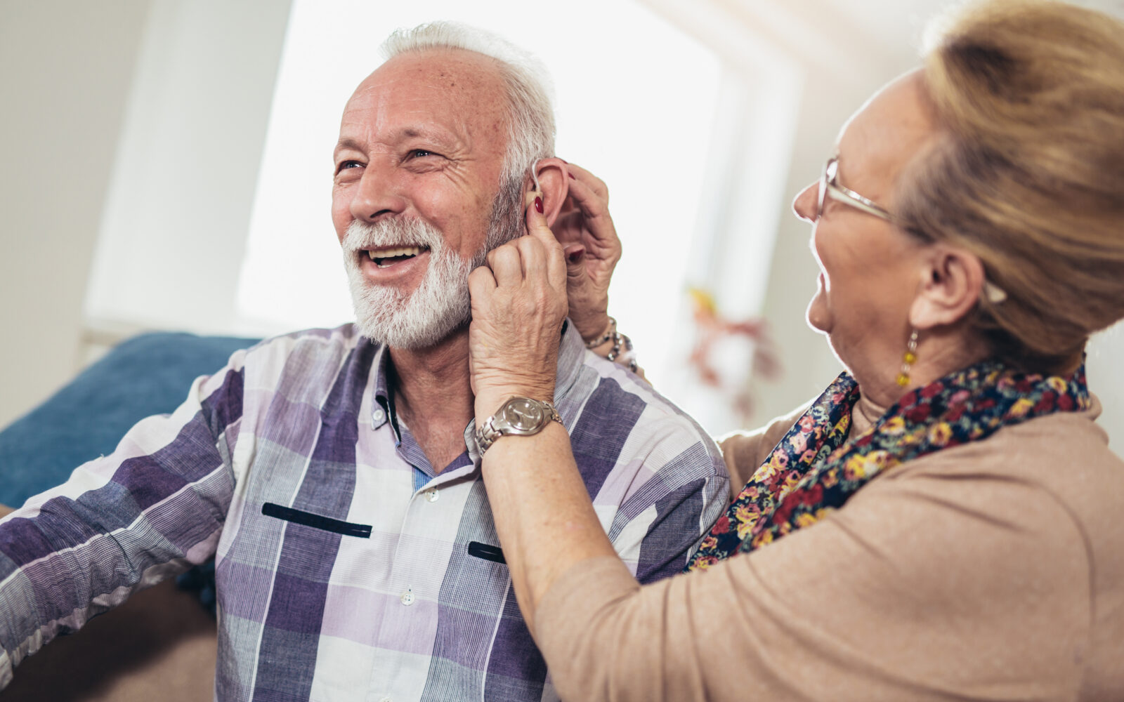 Older man and woman or pensioners with a hearing problem