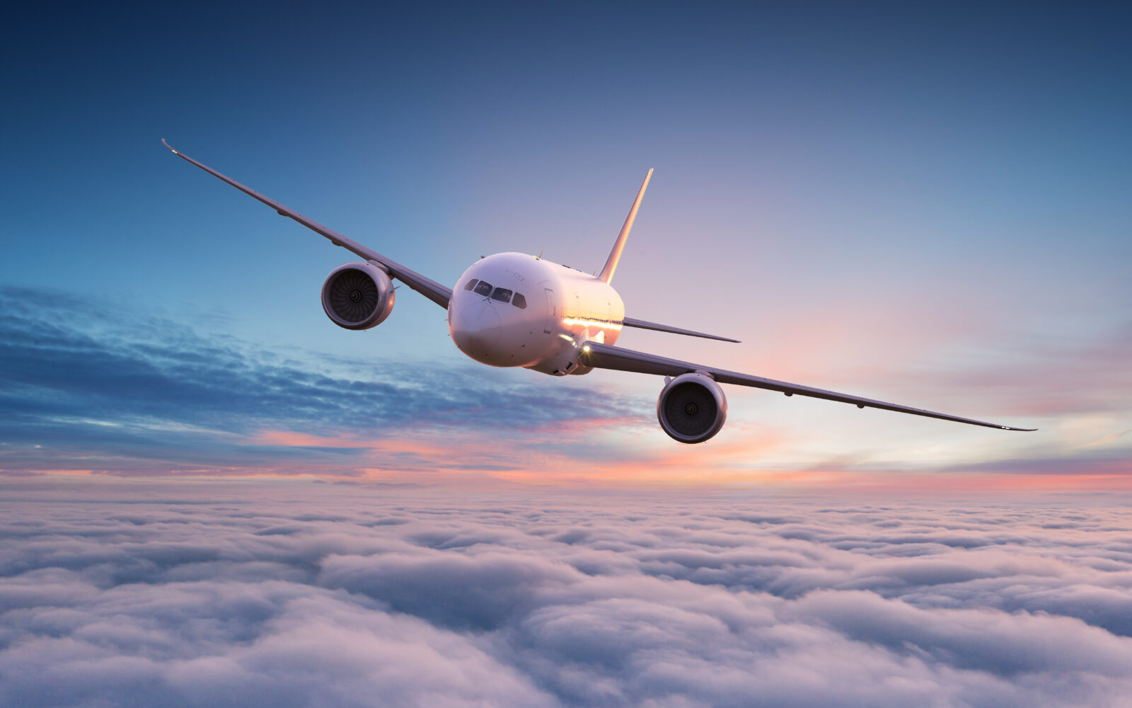 Commercial airplane jetliner flying above dramatic clouds