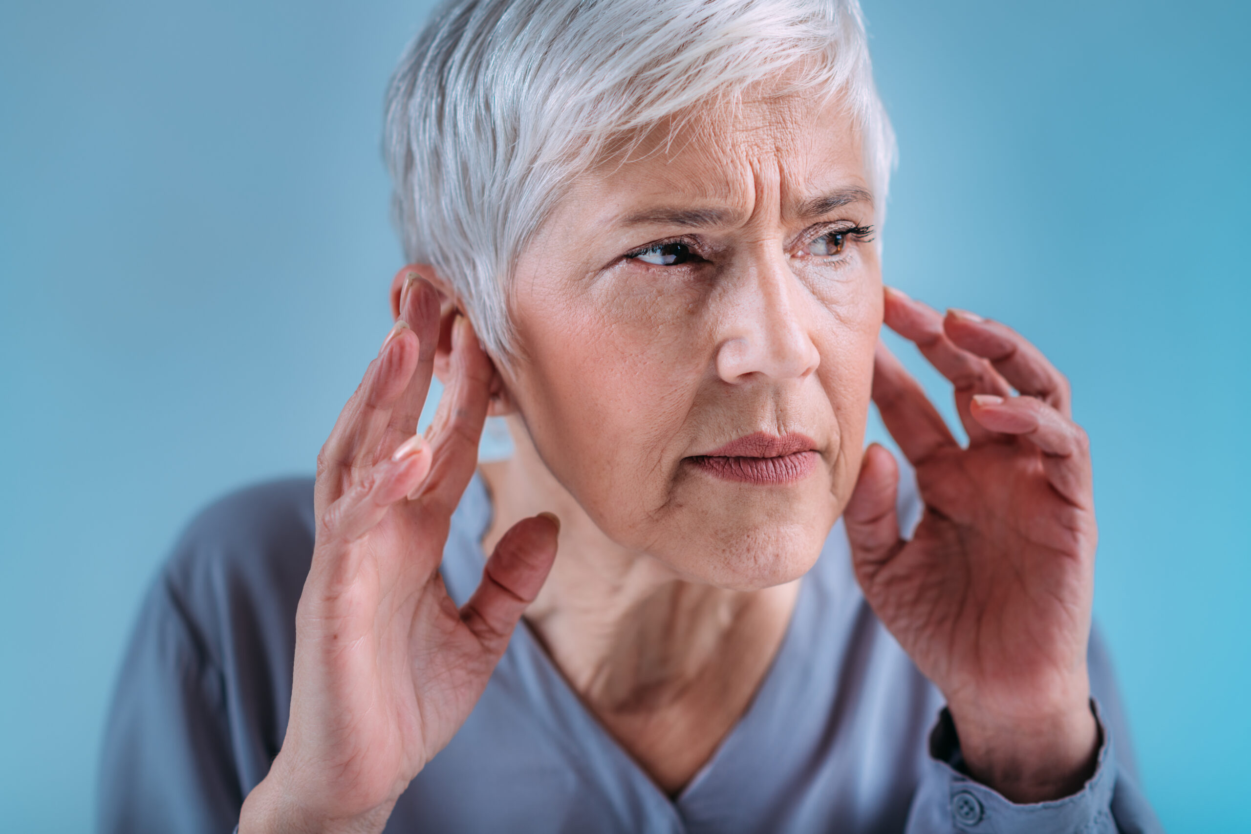 Hearing Loss Senior Woman with Symptoms of Hearing Loss