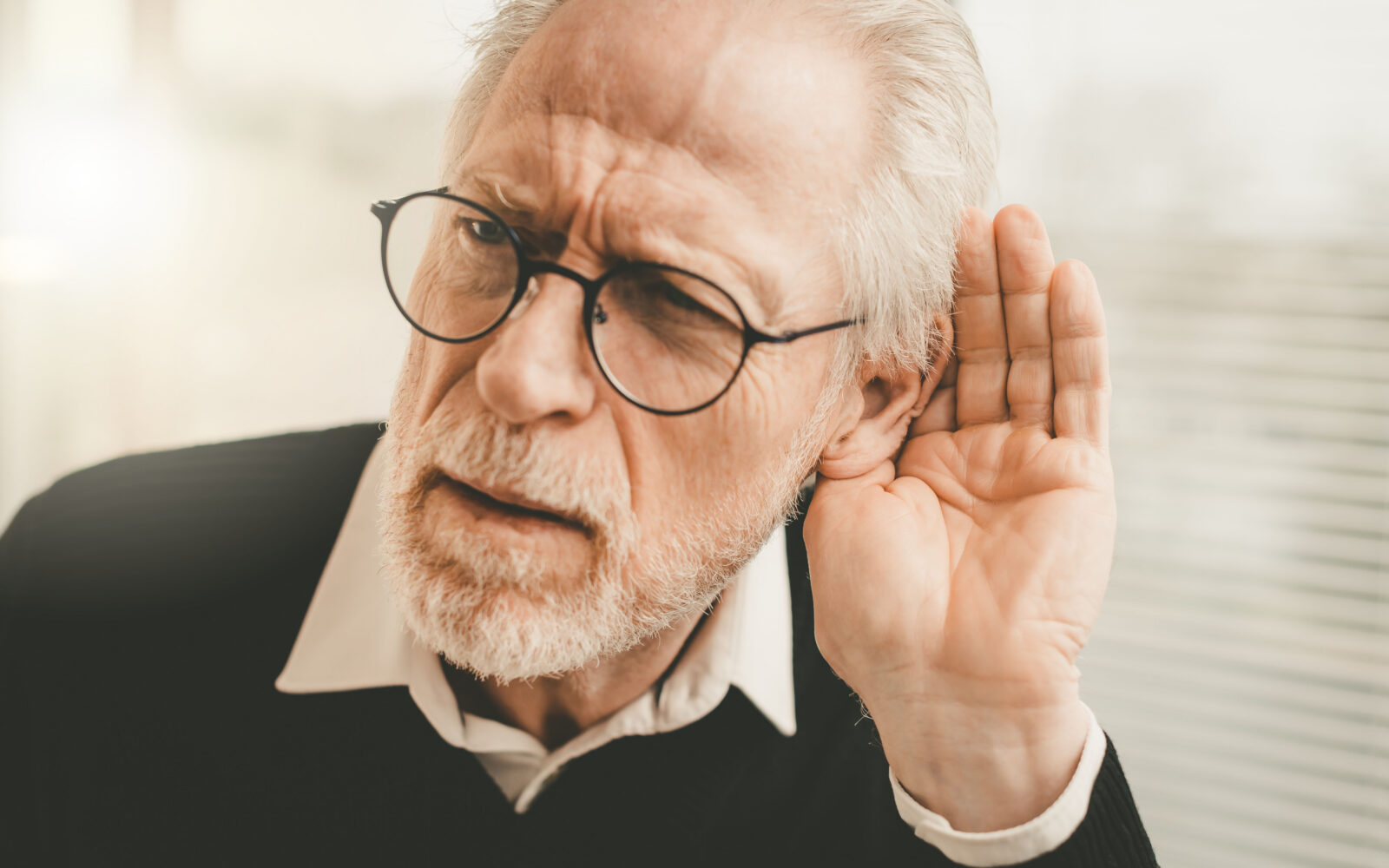 Senior man with hearing problems
