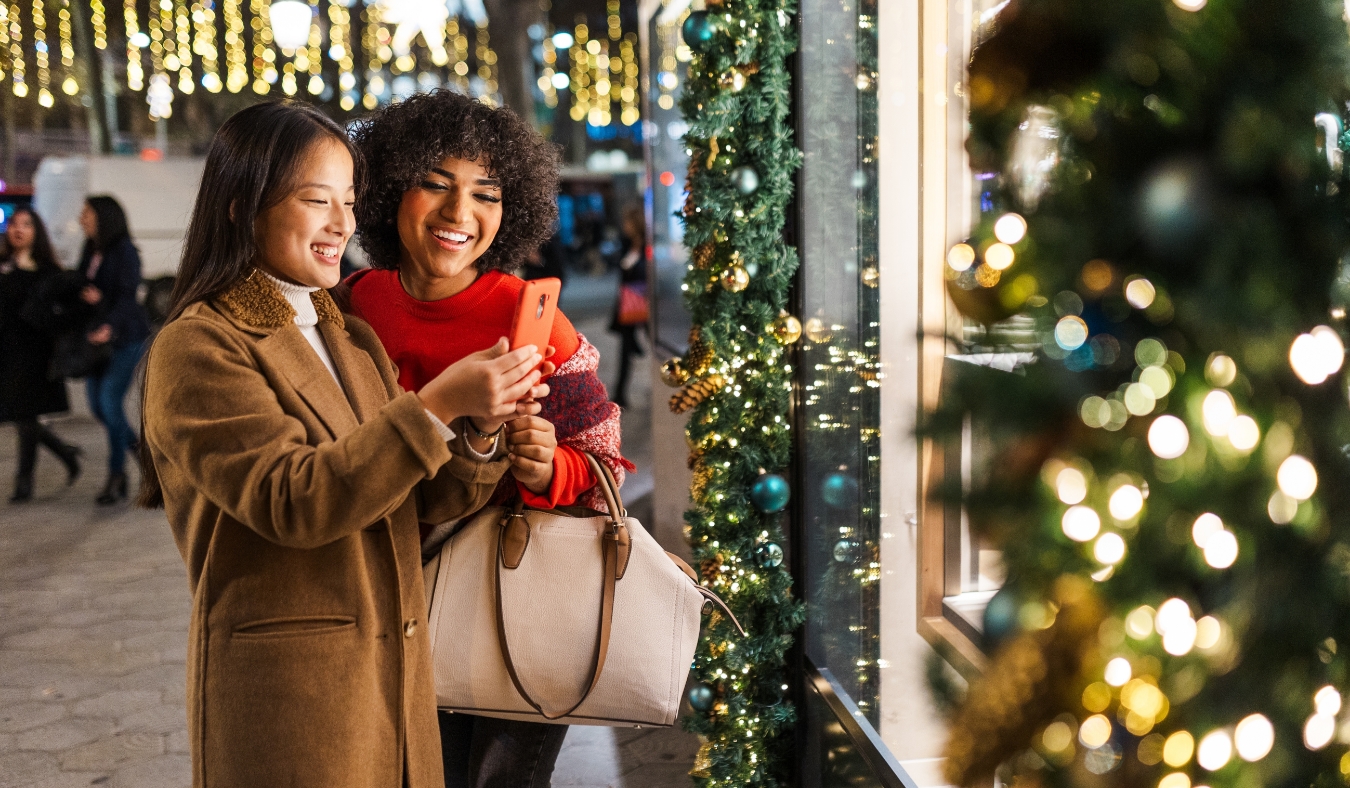 friends taking image of holiday window display