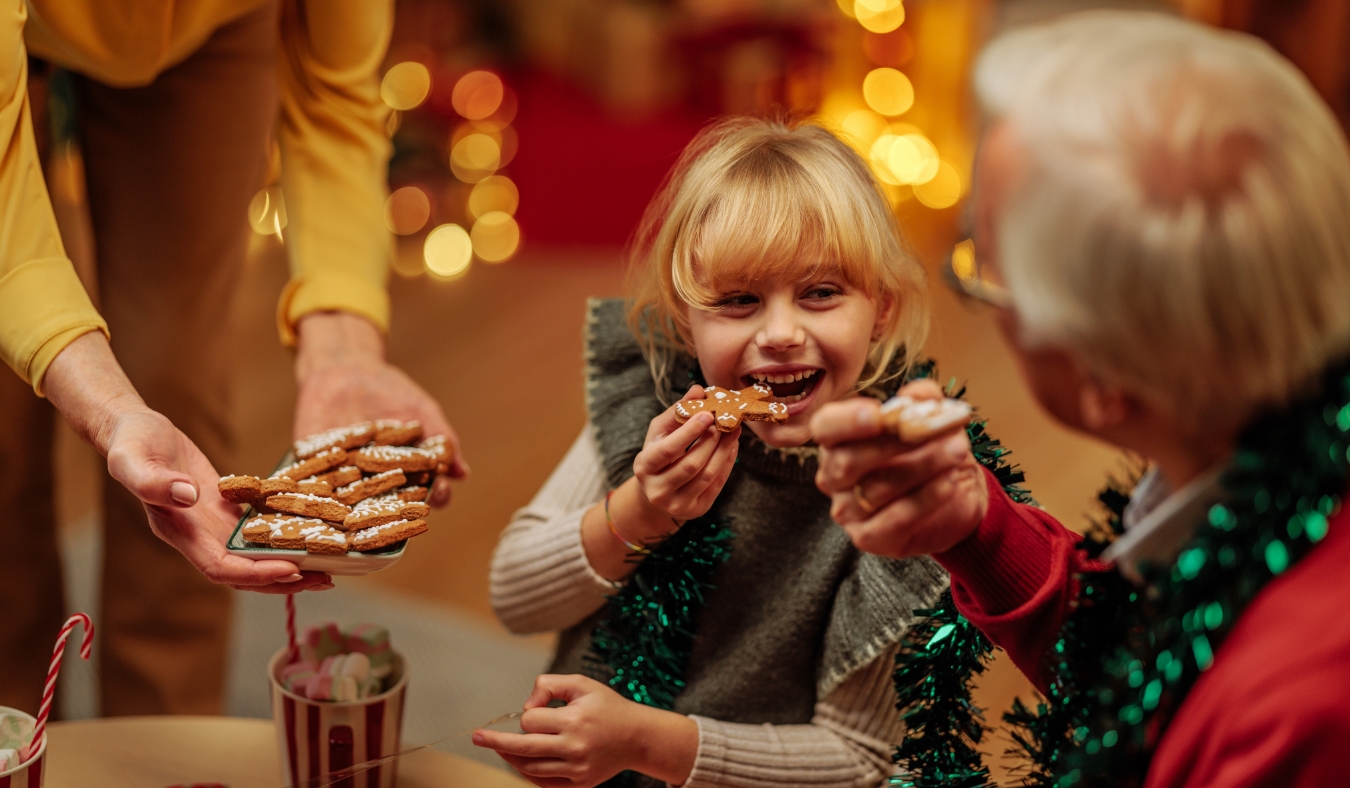 granddaughter eating christmas cookies with granddaughter