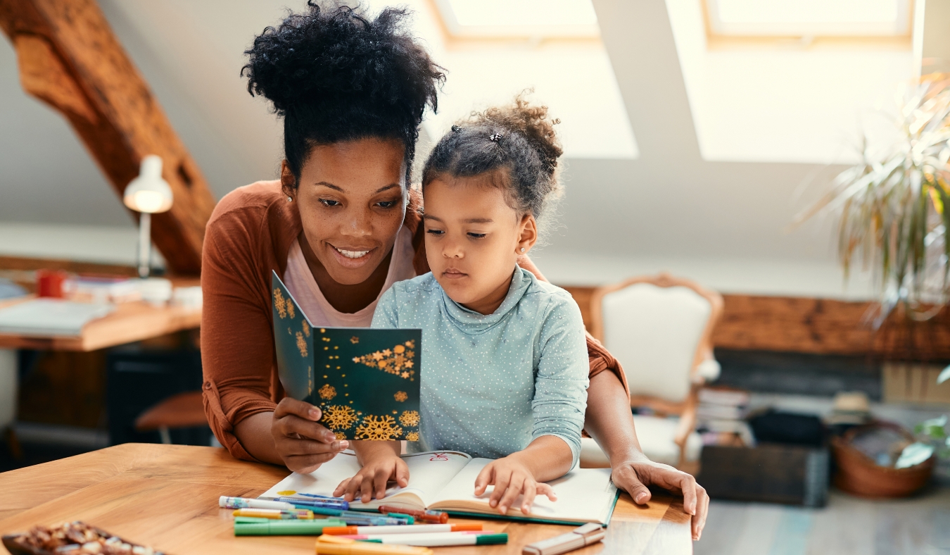 mother and daughter reading Christmas card