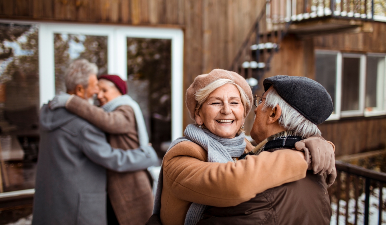 couple friends greeting eachother at cozy cabin
