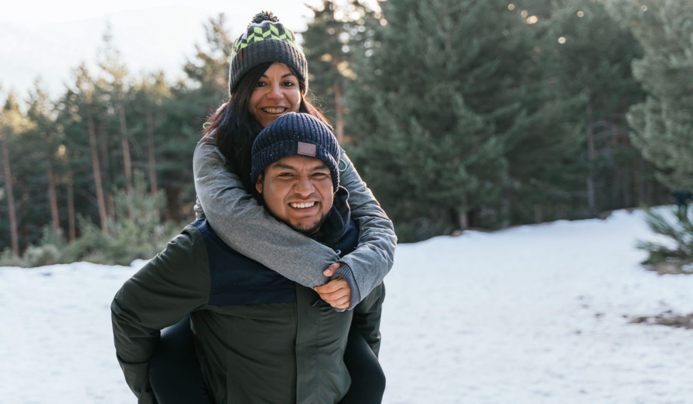 couple playing together in the snow