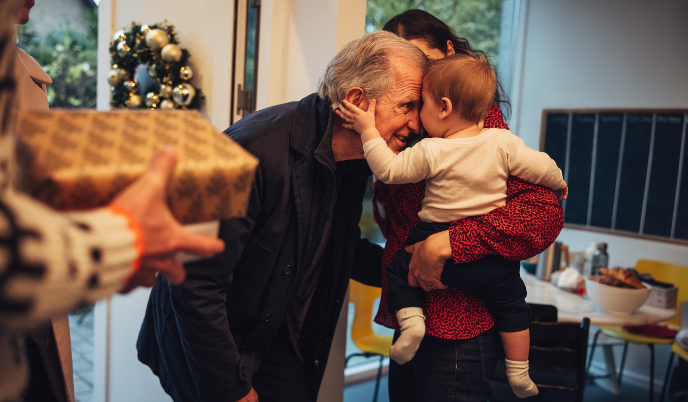 grandfather greeting grandson at holiday gathering