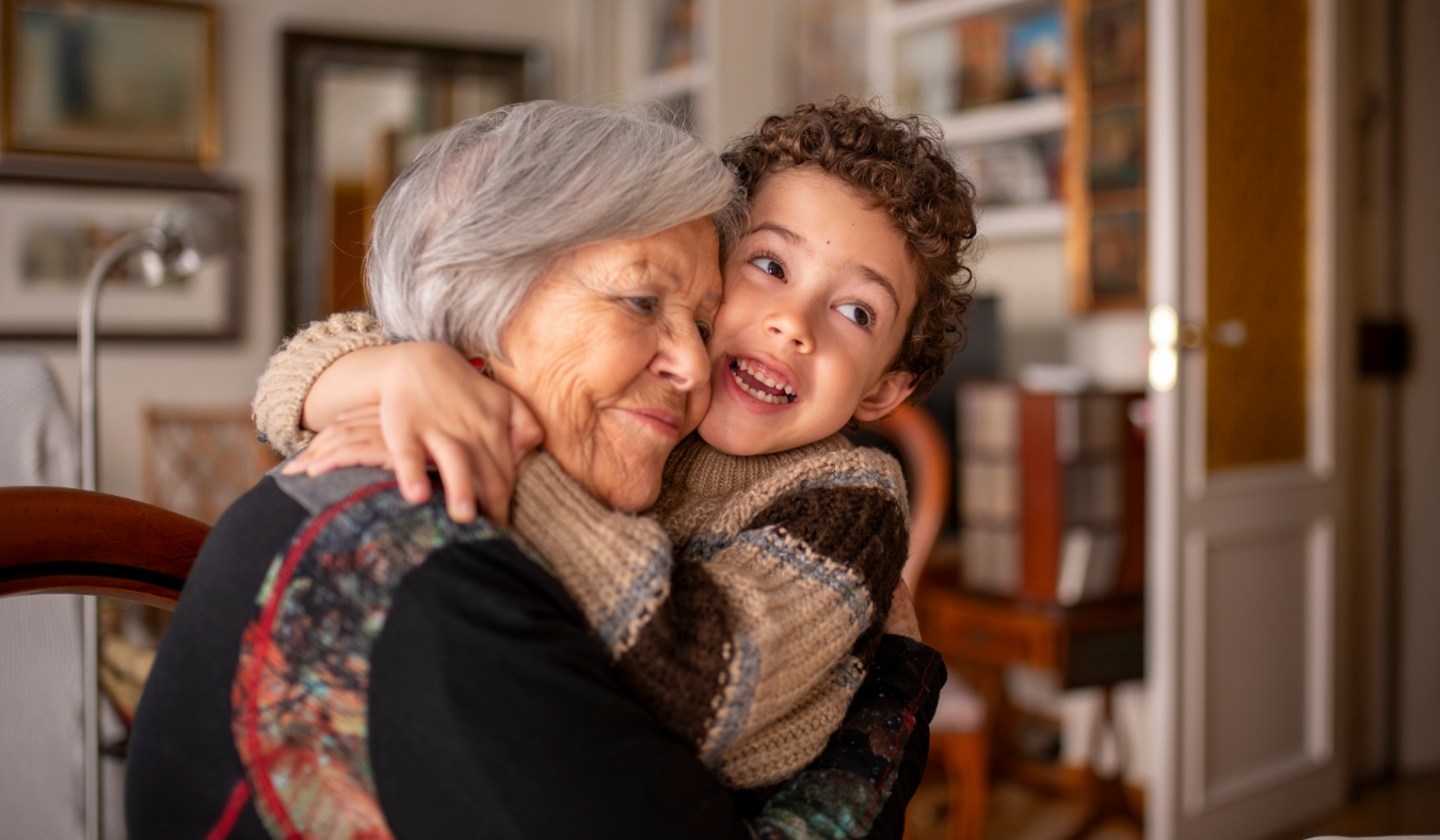 grandmother hugging grandson in warm sweaters