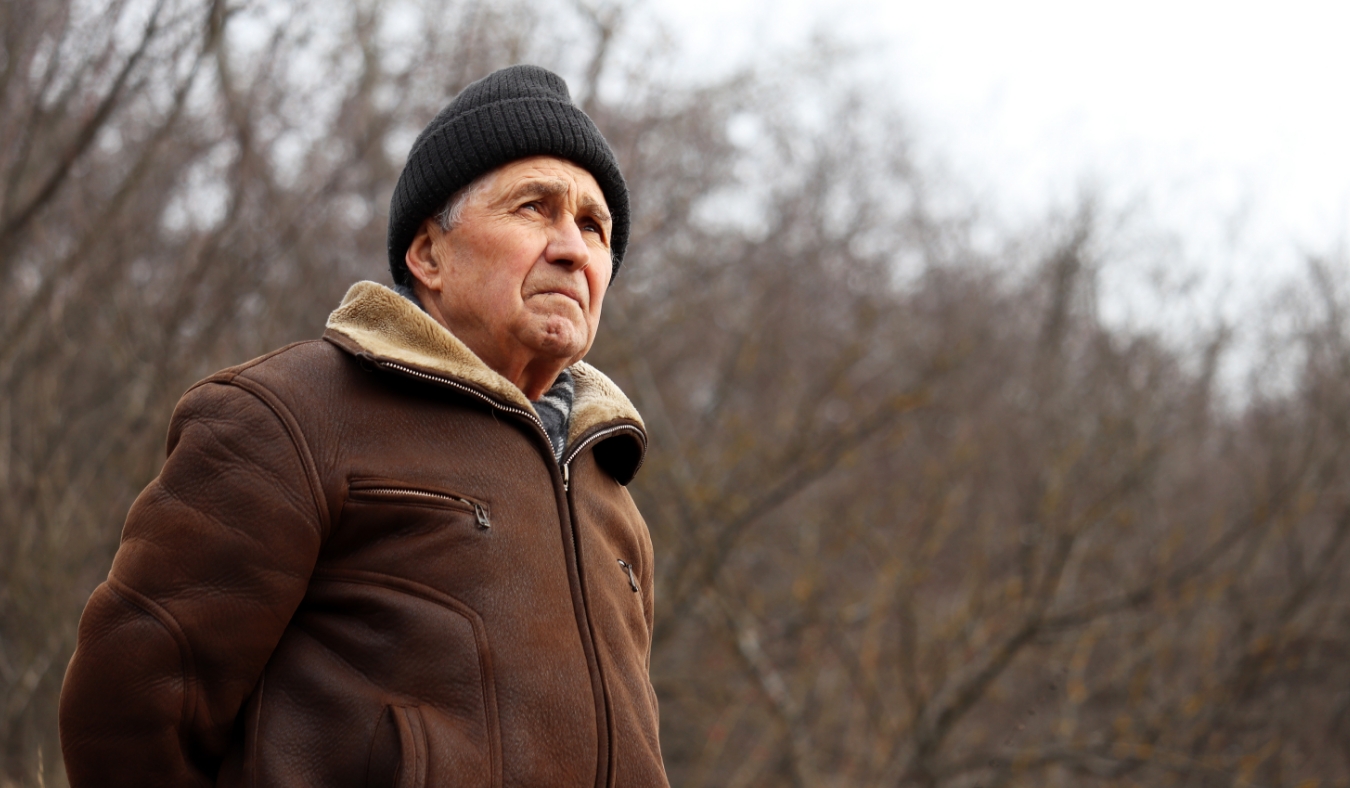 older man looking to the sky on a winter day
