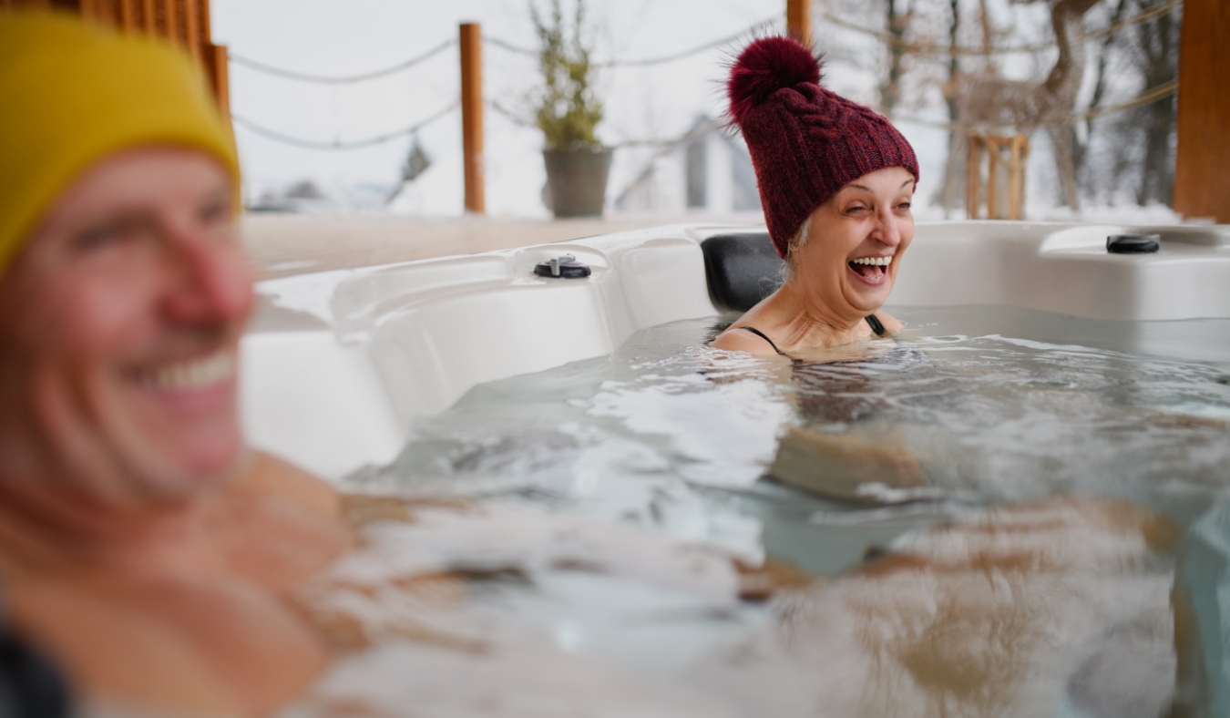 senior couple enjoying hot tub on a cold day