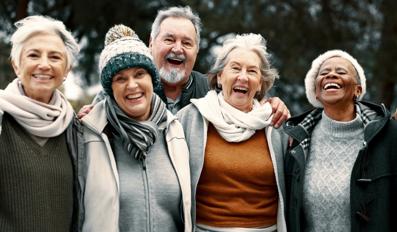 senior friends dressed for cold weather smiling