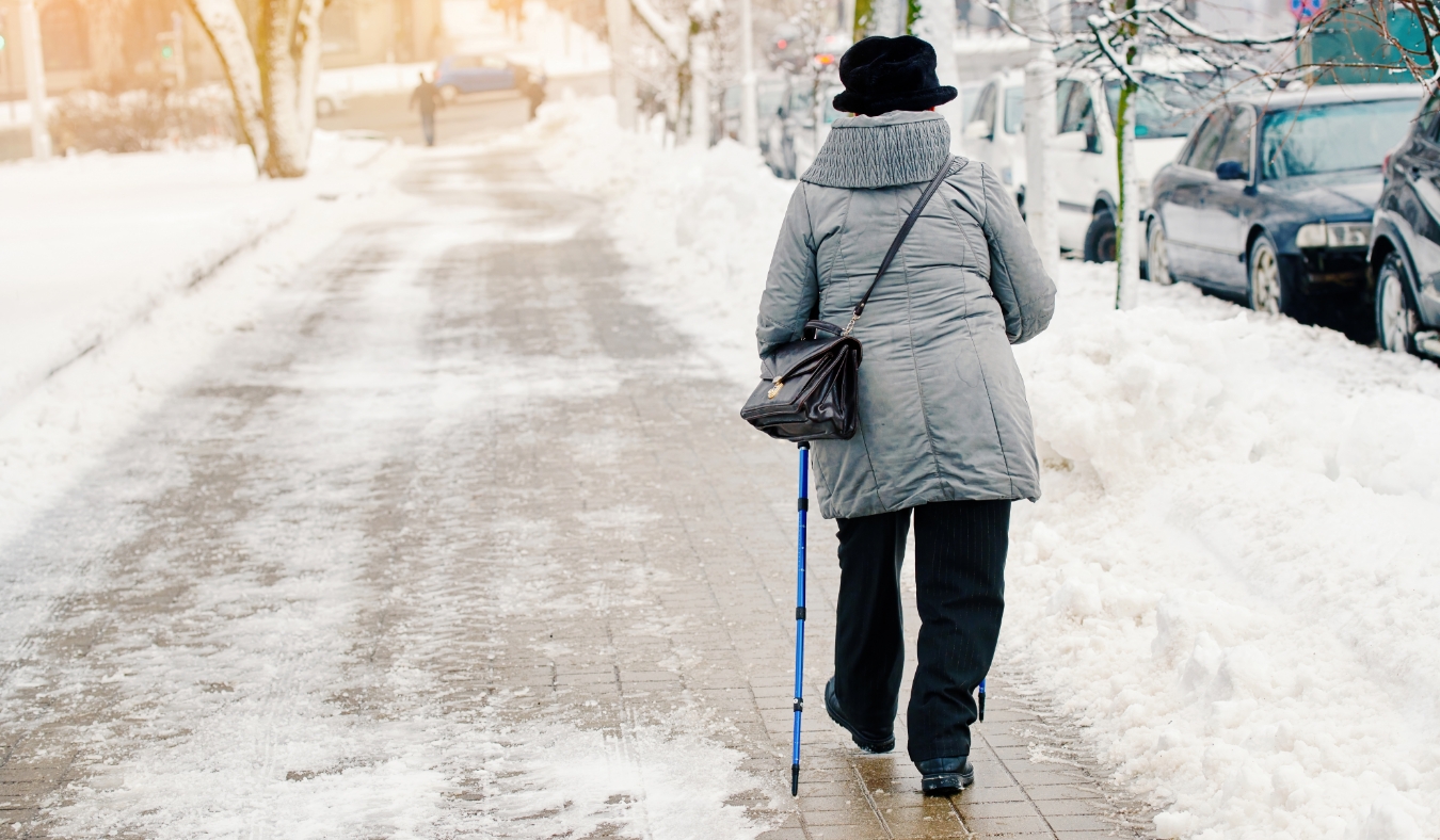woman walking in park on a snowy day