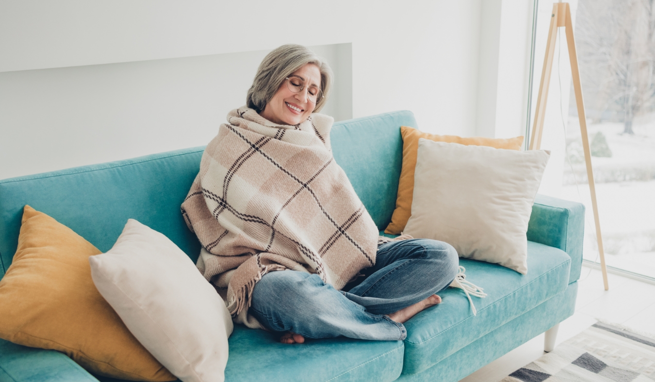 woman wrapped in blanket smiling