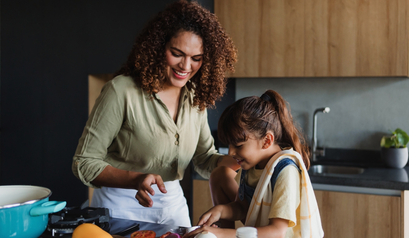 mother and daughter cooking dinner together