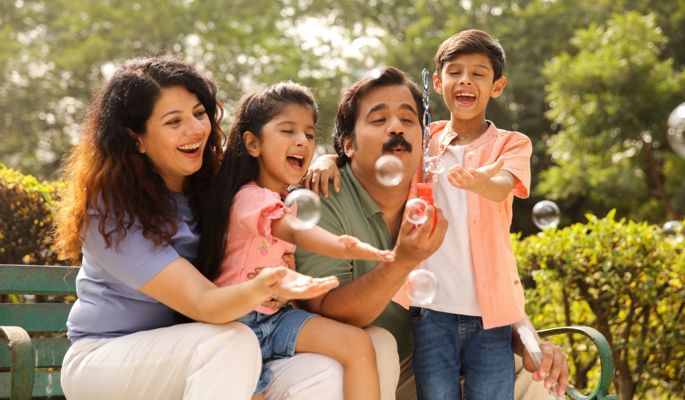 indian family playing bubble enjoying picnic time outdoor