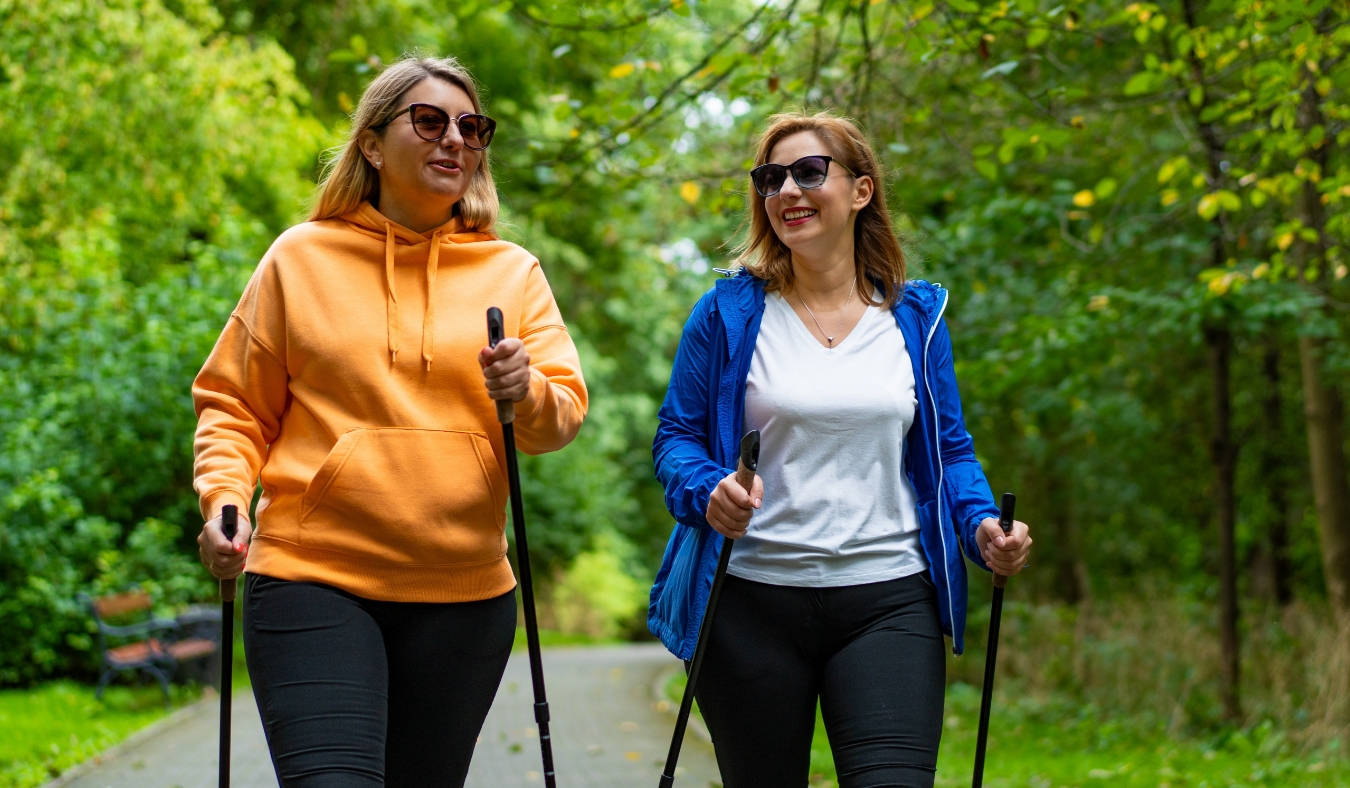 two senior friends hiking on a sunny day