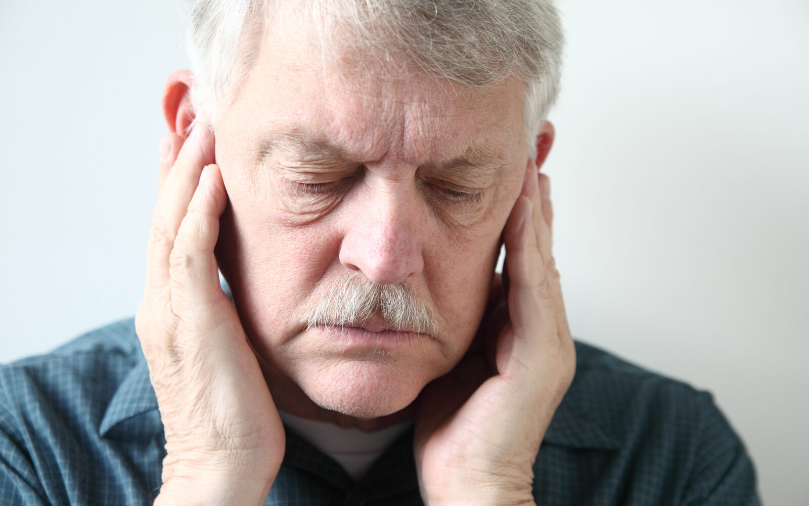 senior with pain in front of ears