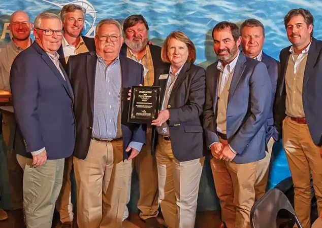 A photo of the Bluewater team holding an award for top 1% worldwide for Regulator sales revenue