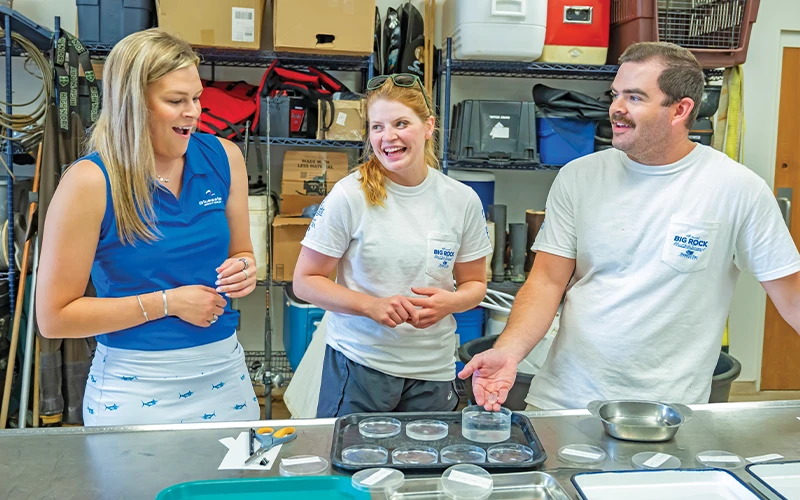 Graduate students explain fish research procedures to visitors at the Big Rock Tournament event