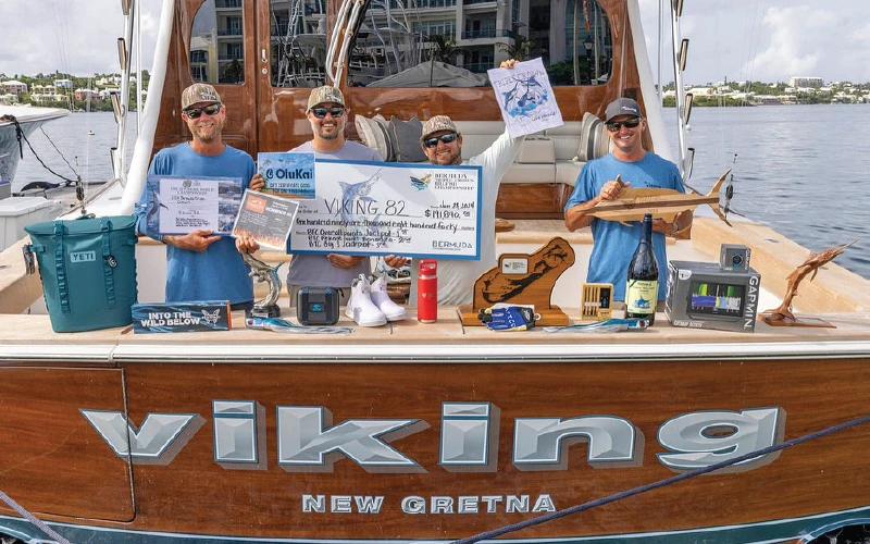 Viking 82 demo team celebrates their Bermuda tournament victory with awards and sponsor gear