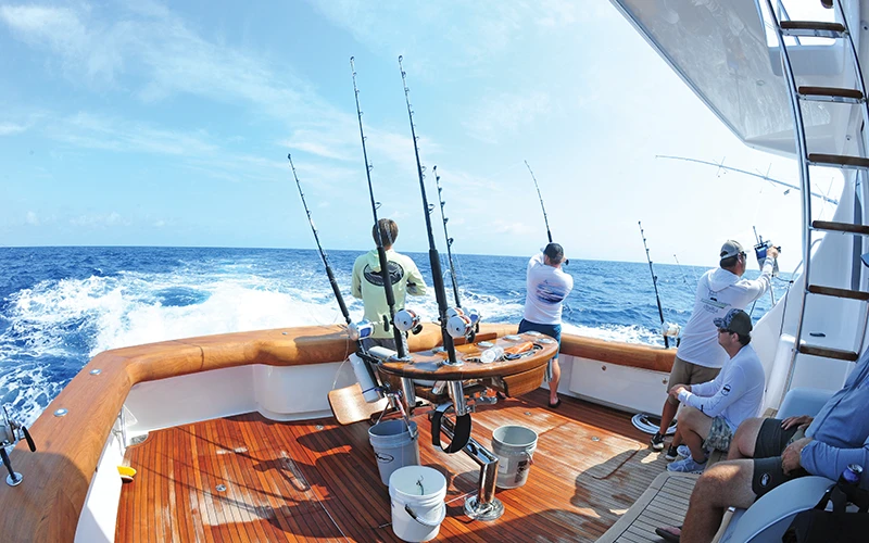 Anglers actively fish from the Viking 64 cockpit during a high-speed offshore troll