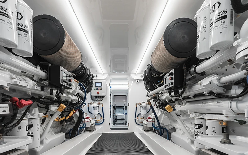 Pristine engine room aboard the Jarrett Bay 68 showcasing twin CAT C32B engines and advanced systems layout