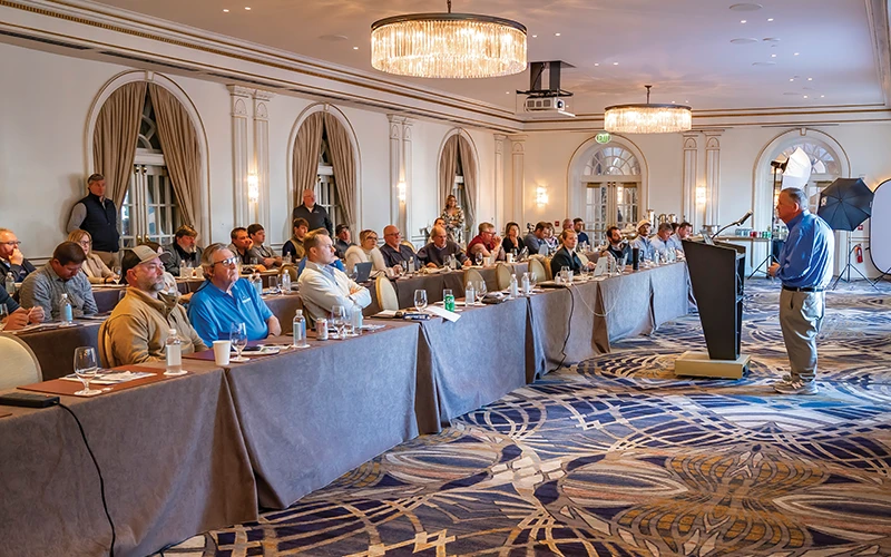 Bluewater team members listen to Randy Ramsey give a speech