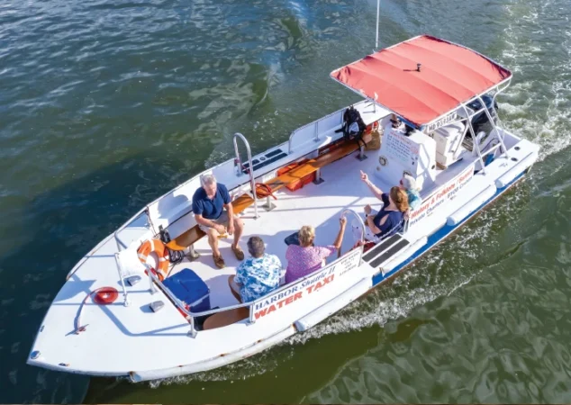 Guests cruising through the Miles River aboard a St. Michaels Harbor Shuttle water taxi