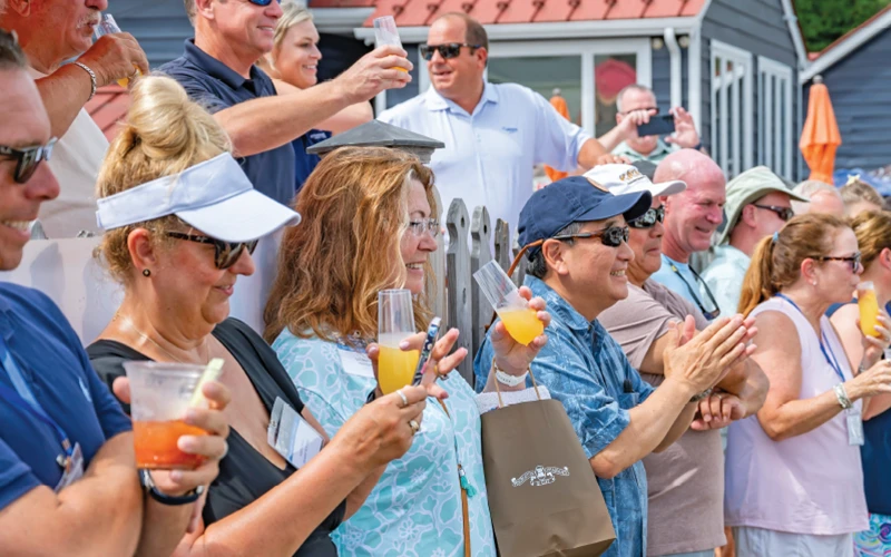 Bluewater Summer Cruise guests raising glasses and celebrating during the christening ceremony