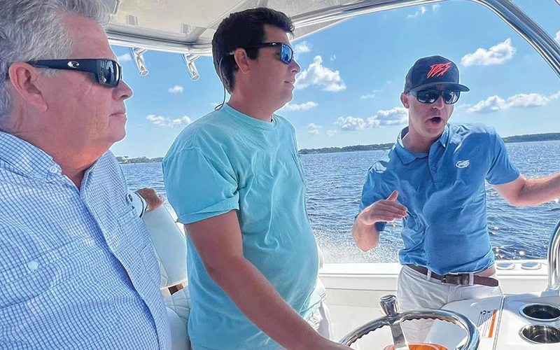 John Donoghue at the helm of his Valhalla V-33 receiving operational guidance from Bluewater Yacht Sales team