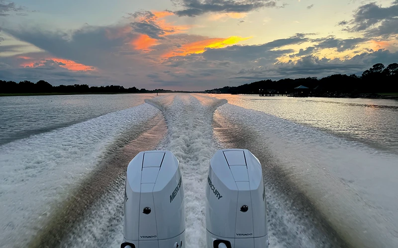 Twin Mercury 400 V10 outboards powering through the water at sunset, leaving a wake behind the Valhalla V-33